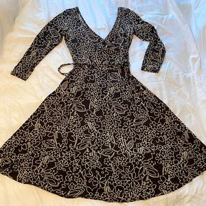 Gathered waist.looks like a wrap dress. Plunging neckline and back